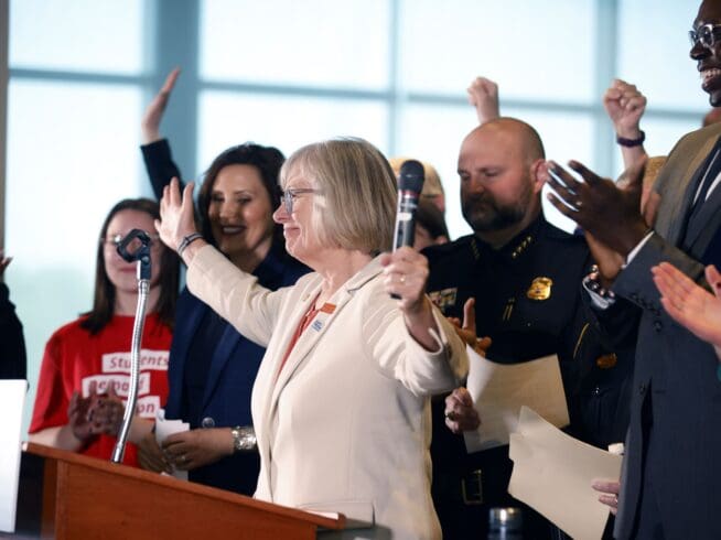 State Sen. Rosemary Bayer, D-Keego Harbor, raises her hands after exclaiming "We did it!" before Michigan Gov. Gretchen Whitmer signed a package of gun bills, Thursday, April 13, 2023, at Spartan Stadium in East Lansing, Mich. (Al Goldis/Detroit News via AP)