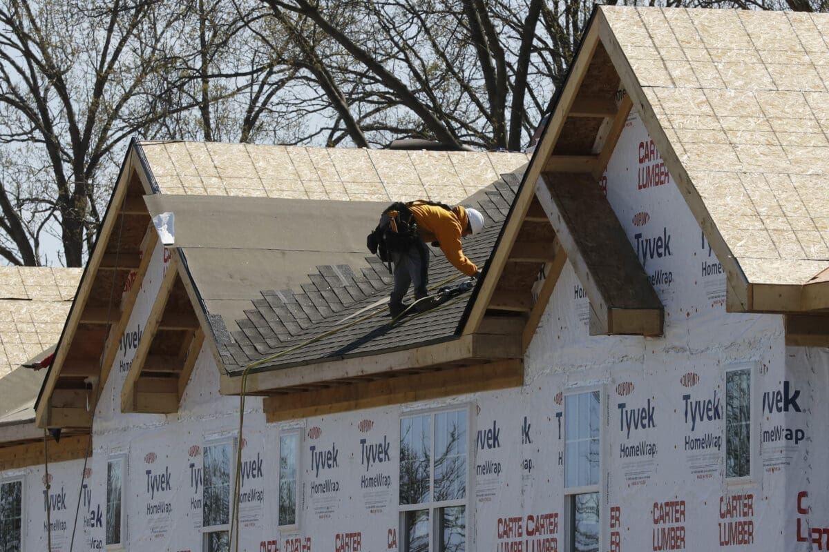 Roofers work on new housing construction, Wednesday, May 6, 2020, in Oak Park, M.I.