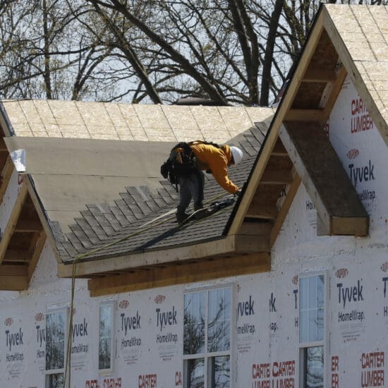 Roofers work on new housing construction, Wednesday, May 6, 2020, in Oak Park, M.I.