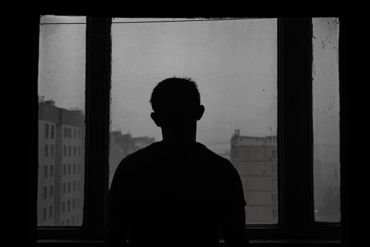 Silhouette of a person in front of a window.