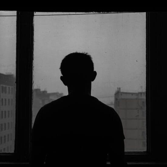 Silhouette of a person in front of a window.