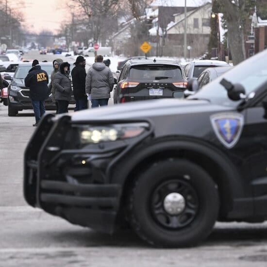 Detroit Police, Michigan State Police and ATF agents work the scene at West McNichols and Log Cabin in Detroit on the border of Highland Park, Mich. on Thursday, Feb. 2, 2023. (Robin Buckson/Detroit News via AP)